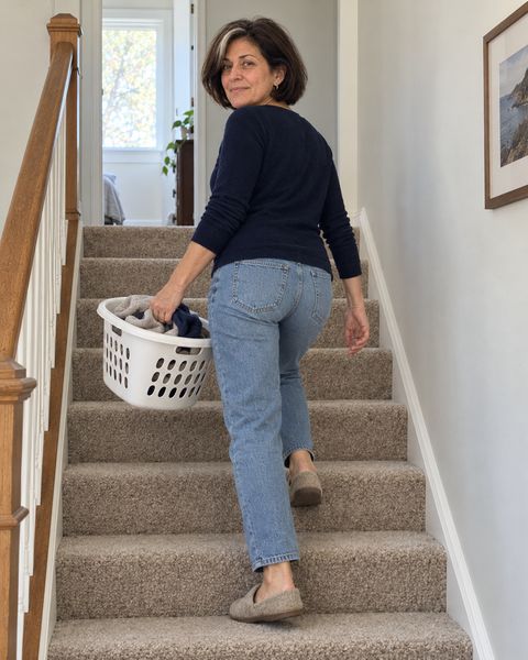 Walking up the stairs at home with a laundry basket, not holding the rail