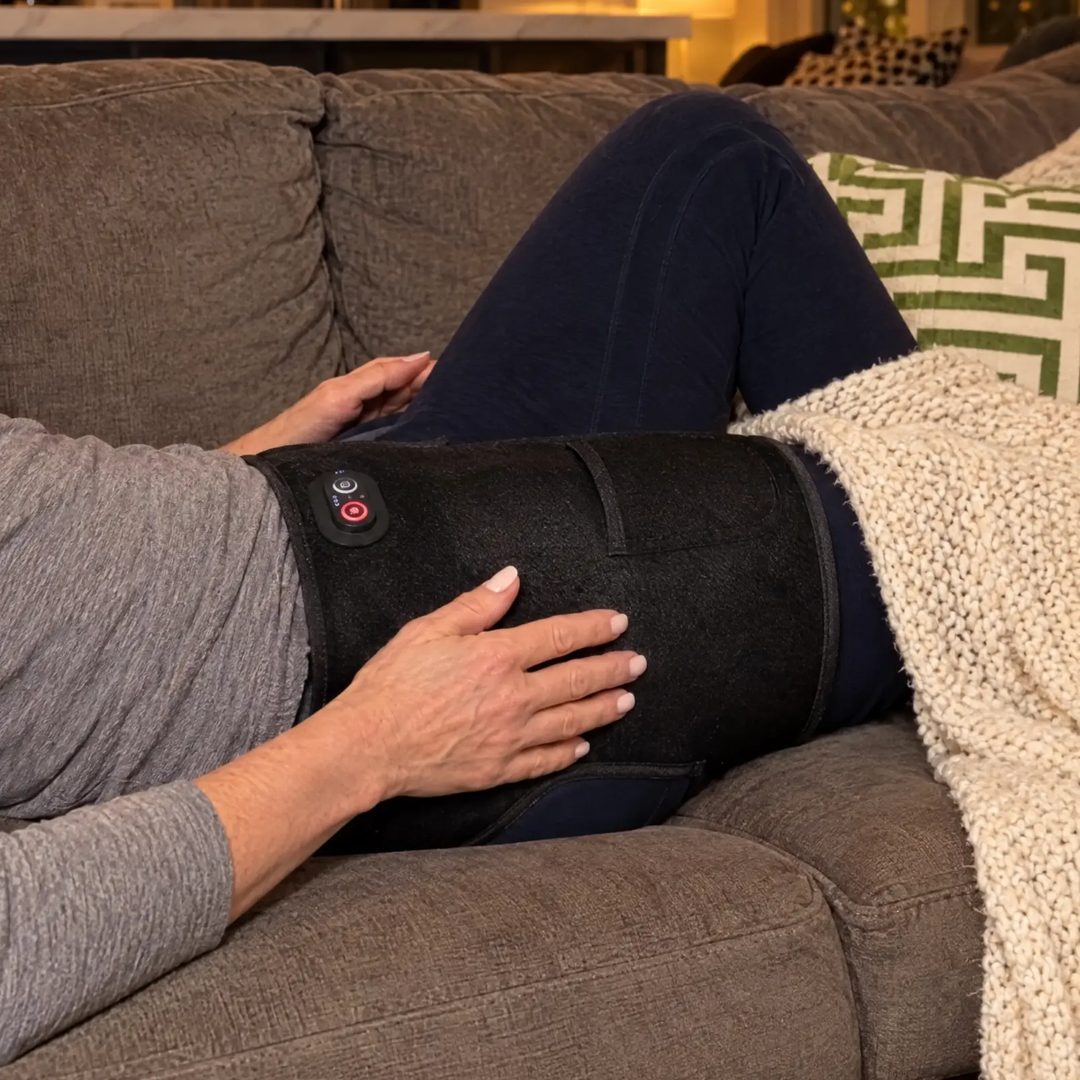 The 4-in-1 Hip Therapy Belt worn while lying on the couch