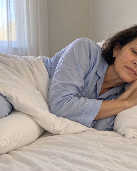 Asleep on her side in the morning with a pillow between her knees